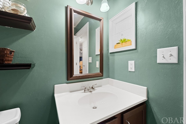 bathroom with toilet and vanity