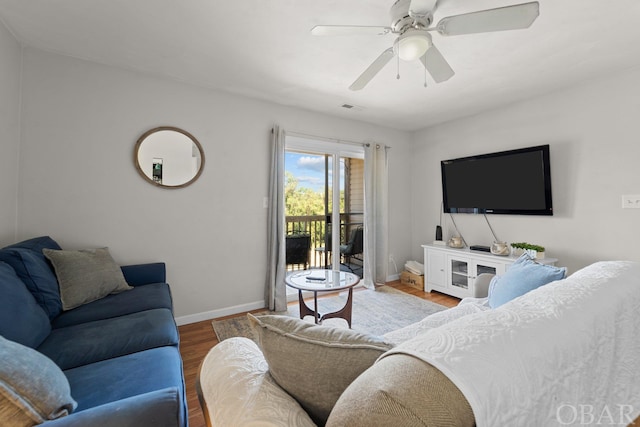 living area with ceiling fan, wood finished floors, and baseboards