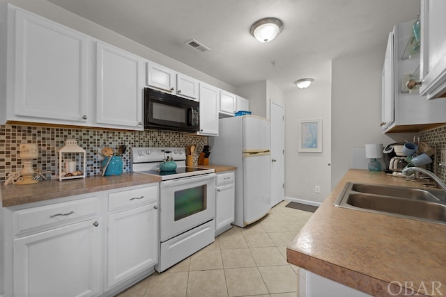 kitchen with white appliances, white cabinetry, a sink, and backsplash