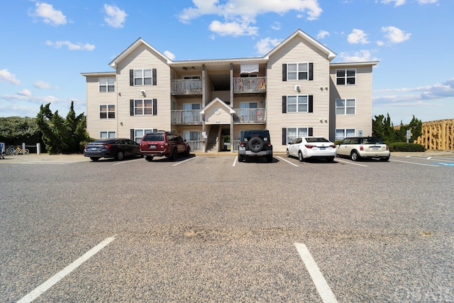 view of building exterior featuring uncovered parking