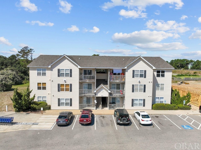 view of property featuring uncovered parking