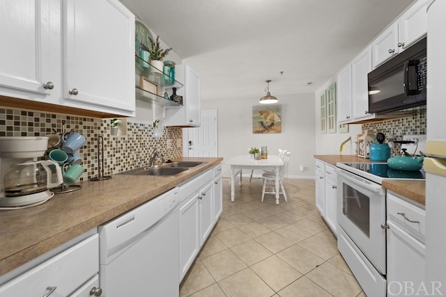 kitchen featuring decorative light fixtures, white cabinets, a sink, light tile patterned flooring, and white appliances