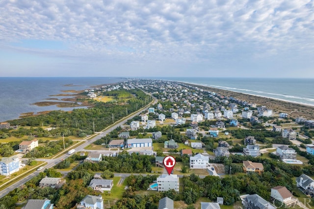 bird's eye view with a residential view, a water view, and a beach view