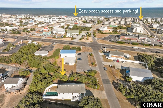 birds eye view of property featuring a water view and a residential view