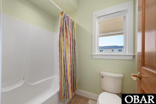 bathroom featuring tile patterned floors, toilet, and baseboards