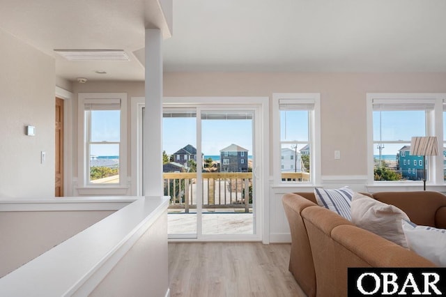 interior space with light wood-style flooring, visible vents, and a wealth of natural light