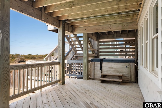 wooden deck featuring stairway and a hot tub