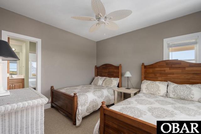 carpeted bedroom with connected bathroom and ceiling fan