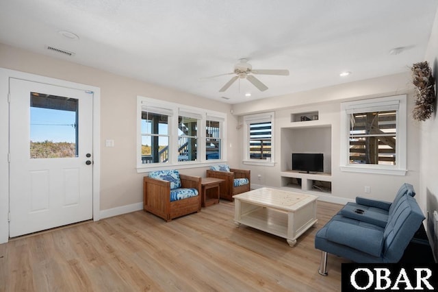 living area featuring visible vents, a ceiling fan, recessed lighting, light wood finished floors, and baseboards