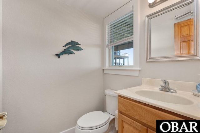 bathroom featuring toilet and vanity