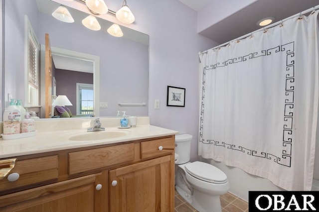 bathroom featuring toilet, vanity, and tile patterned flooring