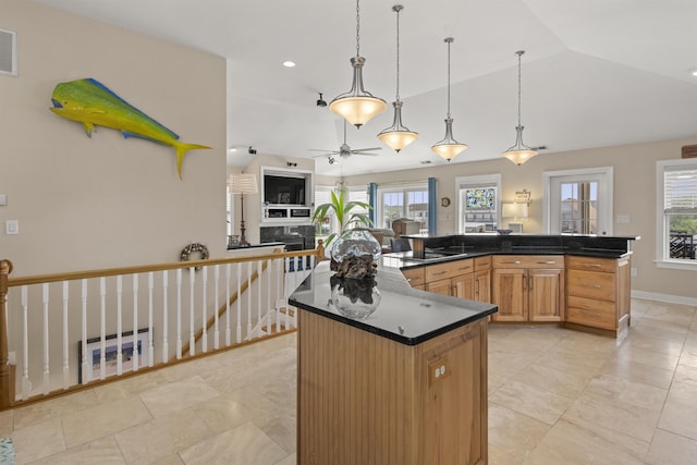 kitchen featuring dark countertops, a kitchen island, open floor plan, black electric cooktop, and vaulted ceiling