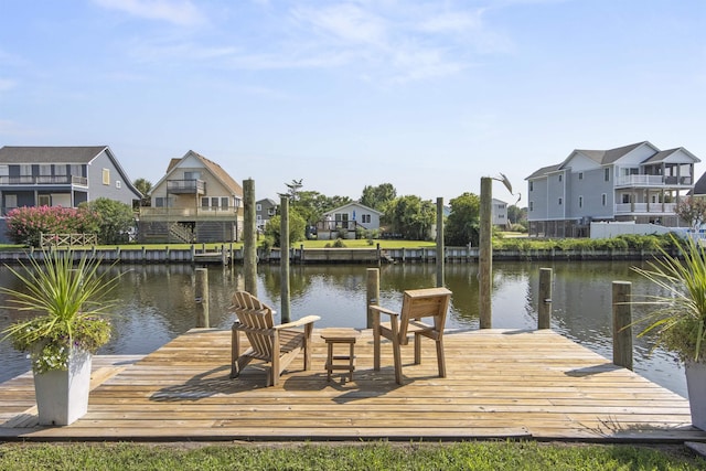 dock area with a water view and a residential view