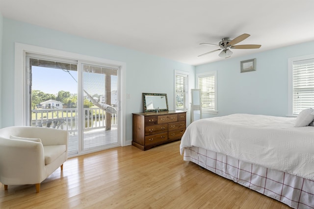 bedroom with light wood-type flooring, access to outside, and a ceiling fan