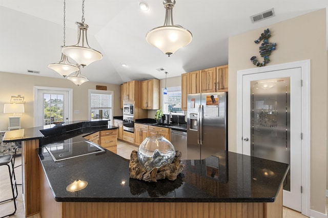 kitchen featuring stainless steel appliances, dark countertops, visible vents, and decorative light fixtures