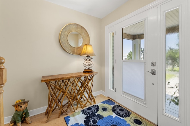 entrance foyer with light wood-type flooring and baseboards