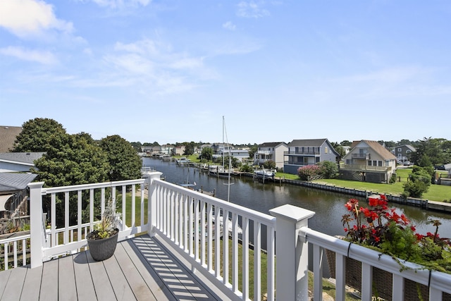 wooden deck with a residential view and a water view