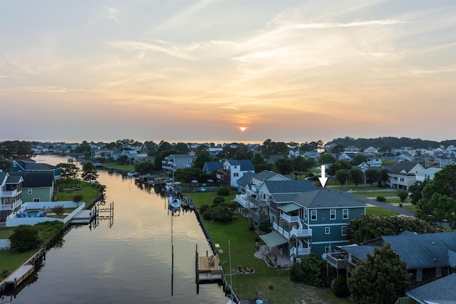 drone / aerial view with a residential view and a water view