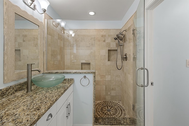 bathroom featuring a shower stall and vanity