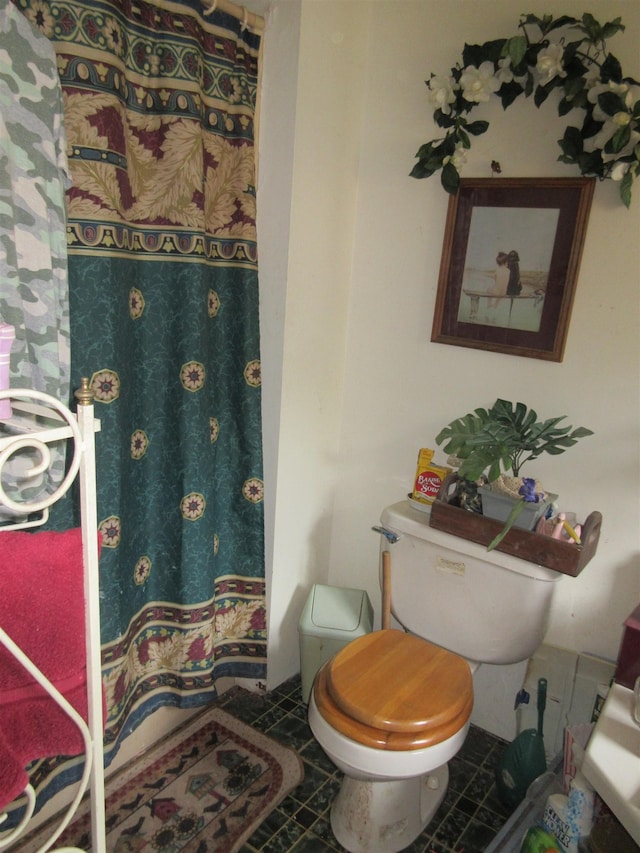 full bath with toilet, tile patterned flooring, and a shower with shower curtain