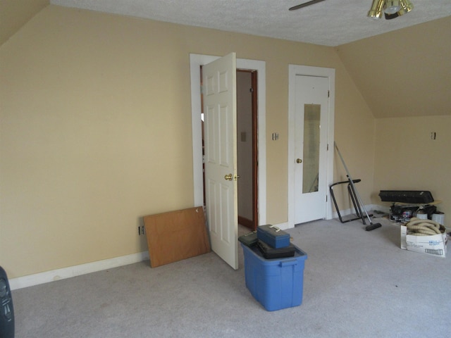 bonus room with light carpet, vaulted ceiling, a textured ceiling, and a ceiling fan