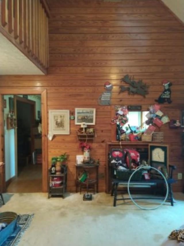 interior space featuring wood walls and a high ceiling