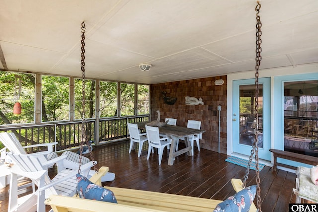 sunroom / solarium with outdoor dining area