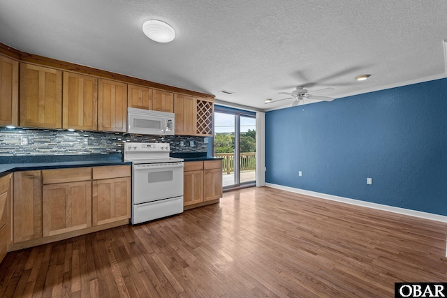 kitchen featuring backsplash, dark countertops, white appliances, dark wood-type flooring, and a textured ceiling