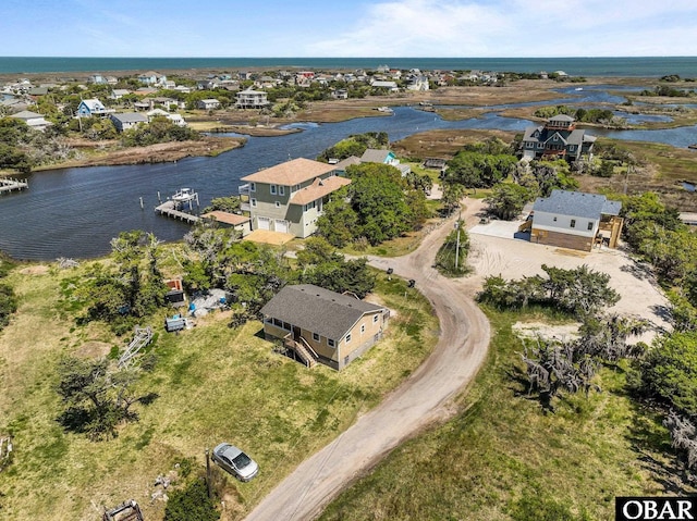 drone / aerial view featuring a residential view and a water view