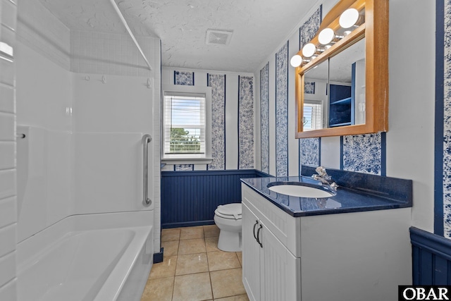full bathroom with wallpapered walls, a wainscoted wall, toilet, visible vents, and bathing tub / shower combination