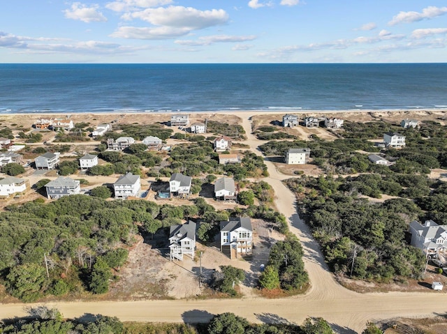 bird's eye view with a water view and a beach view