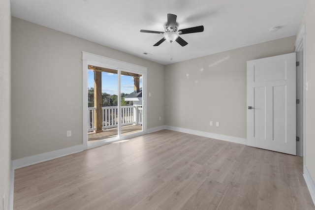 empty room featuring visible vents, light wood-style flooring, baseboards, and ceiling fan