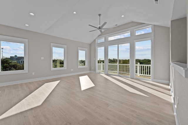 unfurnished living room with baseboards, plenty of natural light, a ceiling fan, and light wood-style floors