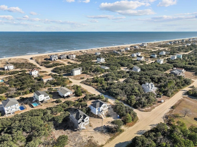 birds eye view of property featuring a water view and a beach view