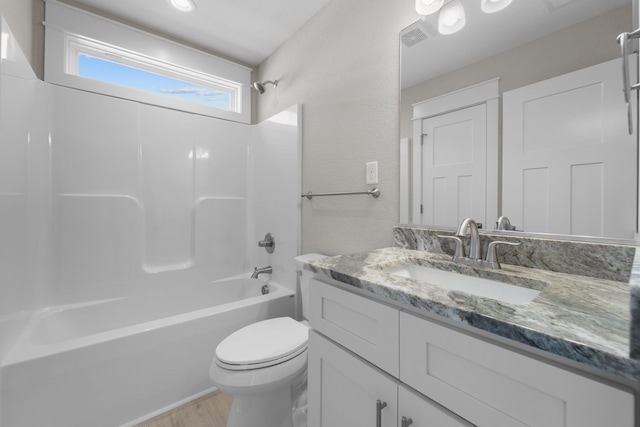 full bathroom with visible vents, toilet, wood finished floors, shower / washtub combination, and vanity