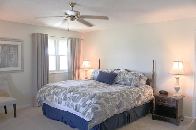 bedroom with baseboards, ceiling fan, and light colored carpet