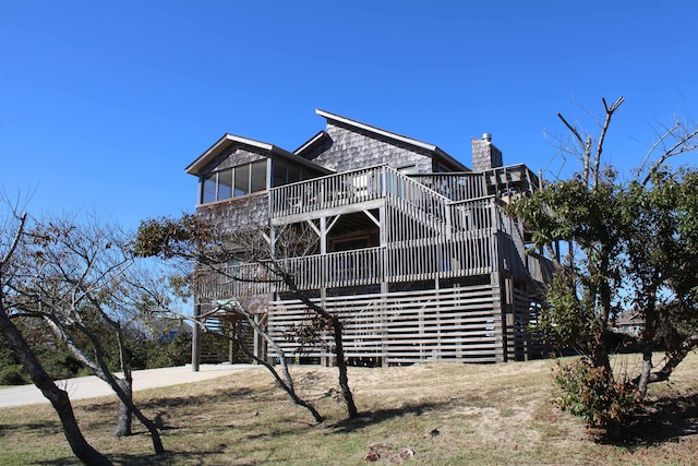 exterior space featuring stairs, a chimney, and a deck