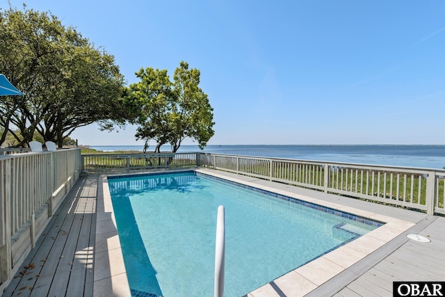 view of swimming pool with a deck with water view and a fenced in pool