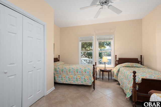 bedroom with ceiling fan, a closet, and baseboards