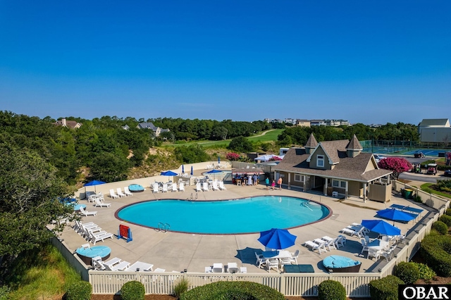 community pool featuring a patio area and fence