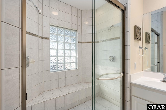 bathroom featuring a stall shower and vanity