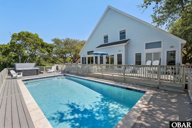 view of swimming pool with a fenced in pool and a deck