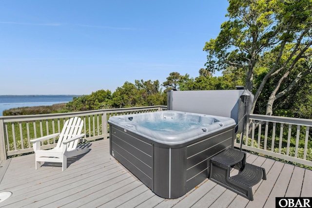 deck featuring a water view and a hot tub