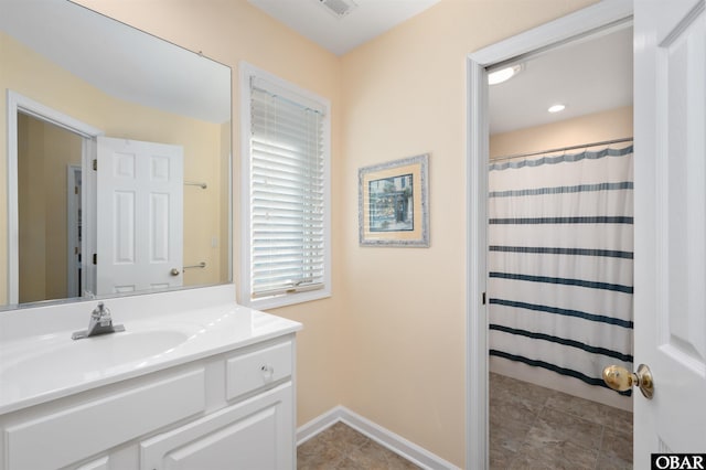 full bath featuring curtained shower, vanity, and baseboards