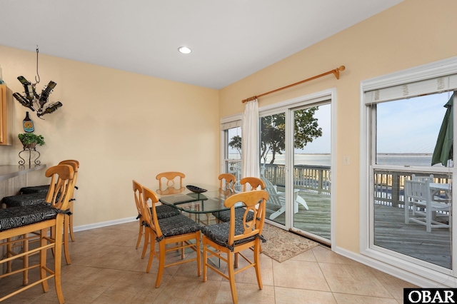 tiled dining room featuring recessed lighting and baseboards