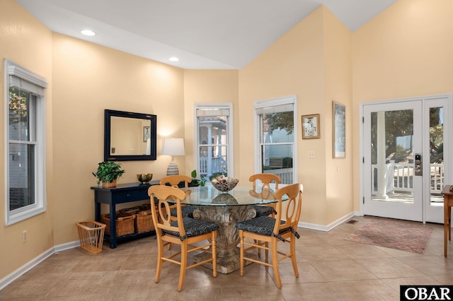 dining space featuring lofted ceiling, light tile patterned floors, baseboards, and recessed lighting