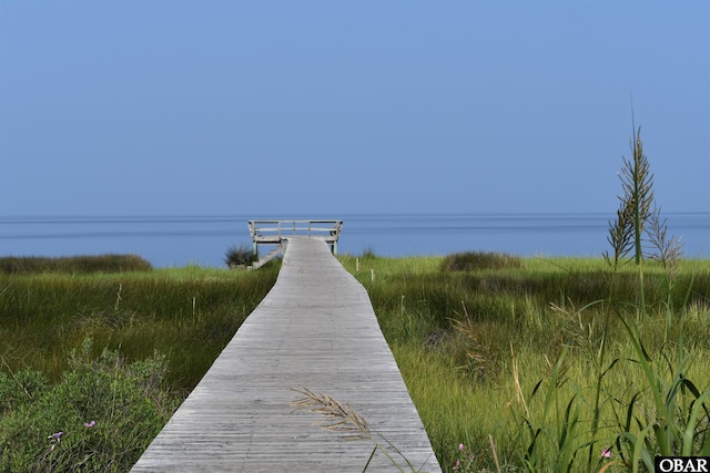 exterior space with a dock and a water view