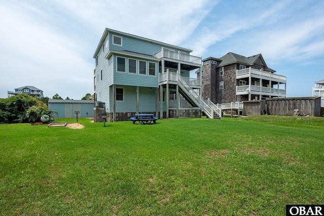 back of property featuring a yard and stairs