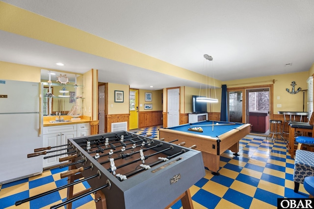 rec room featuring a dry bar, a wainscoted wall, pool table, light floors, and a sink