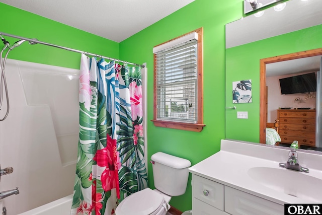 bathroom featuring toilet, shower / bath combo, vanity, and ensuite bathroom